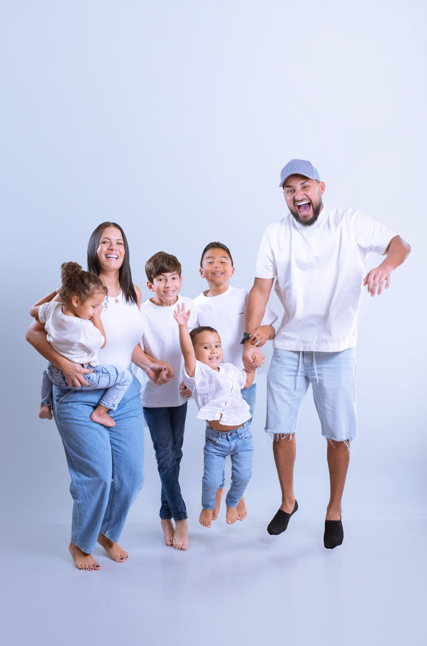 happy family jumping in studio portrait