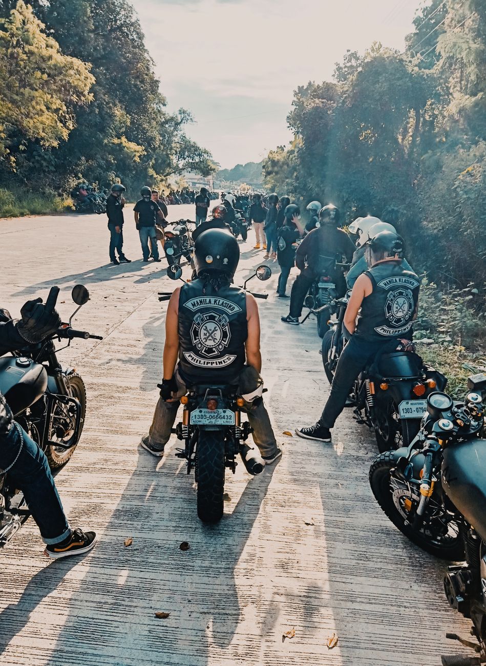 people riding on motorcycle while on the road
